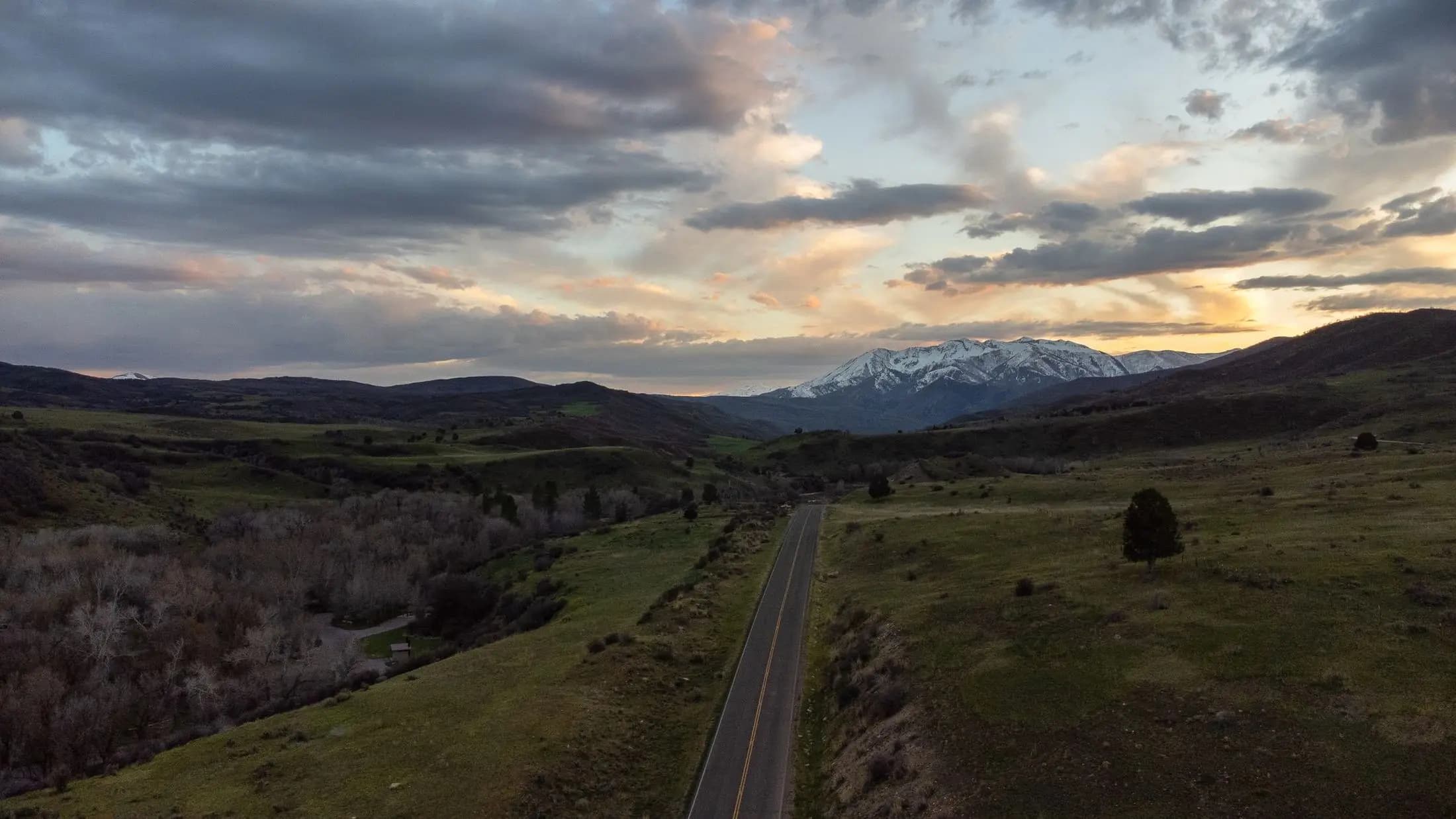 A rural valley near Spanish Fork, Utah, at dusk, a road running toward the mountains